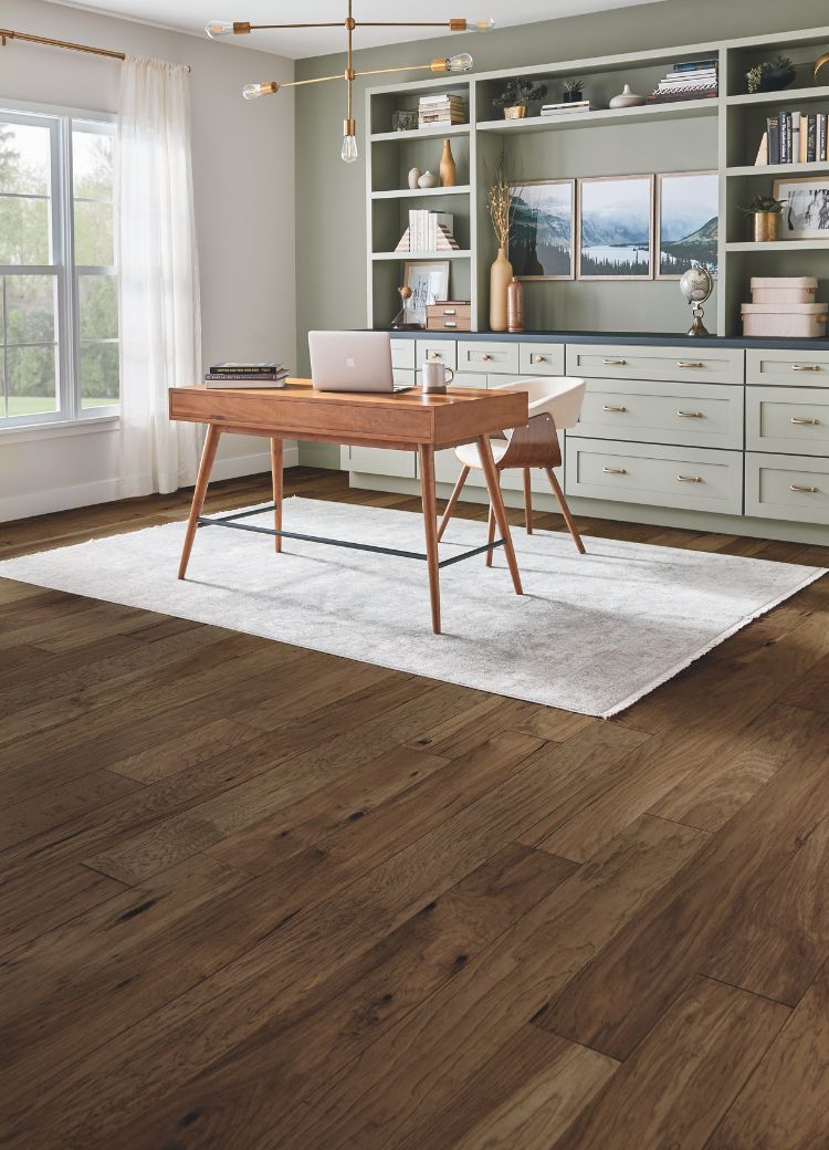 area rugs in a home office with wood look floors and sage green cabinetry